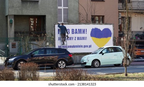 Krakow, Poland March 18, 2022, A Public Utility Worker Hangs A Billboard With Text In Support Of Ukraine On The Streets Of Poland. Russia's War Against Ukraine. Ukrainian Flag In The Heart