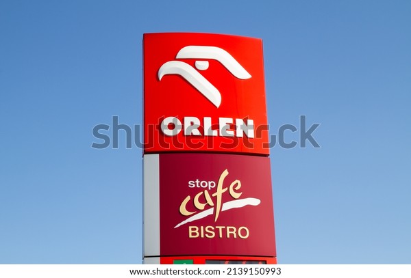 KRAKOW, POLAND - MARCH 21, 2022: Orlen and Stop\
Cafe Bistro sign outside a petrol station. Logo at filling gas\
station forecourt\
pylon.