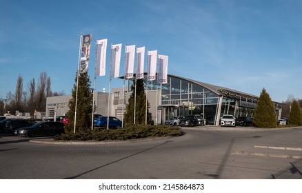 KRAKOW, POLAND - MARCH 27, 2022: Audi Car Dealership Building. German Automobile Manufacturer Auto Salon With Corporation Logo Sign. Luxury Vehicles Automotive Company Brand Logotype Flags.