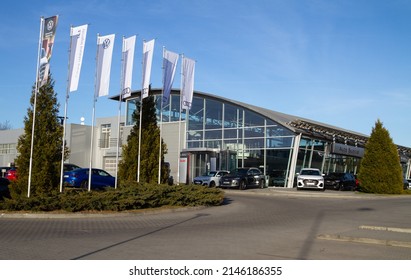 KRAKOW, POLAND - MARCH 27, 2022: Audi Car Dealership Building. German Automobile Manufacturer Auto Salon With Corporation Logo Sign. Luxury Vehicles Automotive Company Brand Logotype Flags.