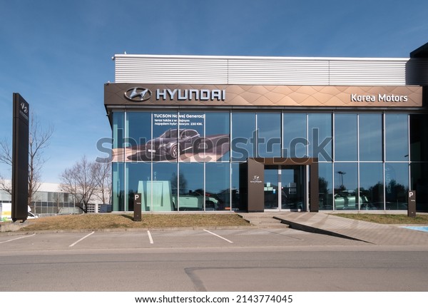 KRAKOW,\
POLAND - MARCH 27, 2022: Hyundai Korea Motors dealership building.\
Korean car manufacturer auto salon with corporation logo sign,\
company brand logotype signboard above\
entrance.