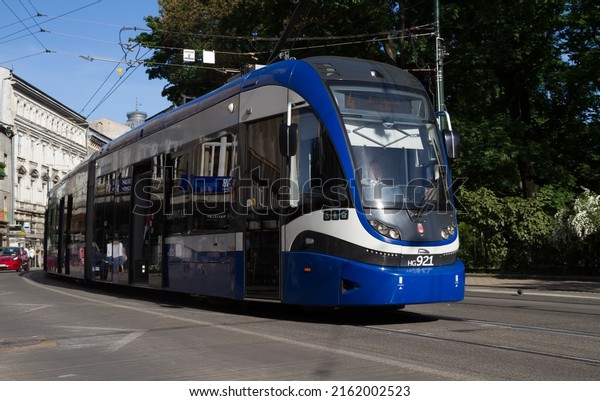 KRAKOW, POLAND - MAY 19, 2022: PESA 2014N -\
Krakowiak type tram wagon. MPK Kraków Public Transport tramway car\
on Basztowa street.
