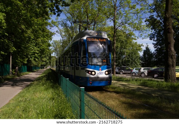 KRAKOW, POLAND - MAY 19,\
2022: GT8N type tram wagon, modernized GT8S car. MPK Kraków Public\
Transport tramway at 3 Maja avenue (3rd of May), near the Błonia\
Park meadow.