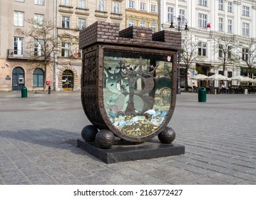 KRAKOW, POLAND - MAY 4, 2022: Skarbonka SKOZK, Money Box Near Town Hall Tower And Cloth Hall (Sukiennice) On Main Market Square In Old Town District Of Kraków. Piggy Bank For Saving City Monuments.