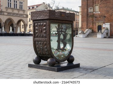 KRAKOW, POLAND - MAY 4, 2022: Skarbonka SKOZK, Money Box Near Town Hall Tower And Cloth Hall (Sukiennice) On Main Market Square In Old Town District Of Kraków. Piggy Bank For Saving City Monuments.