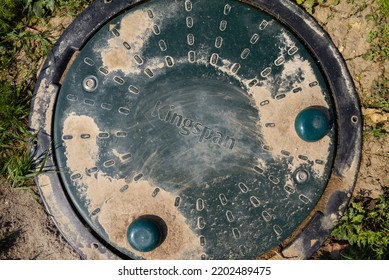 KRAKOW, POLAND - MAY 8, 2022: Kingspan Domestic Sewage Treatment Plant Buried Underground. Waste Tank Hatch With Logo Sign On A Lid.