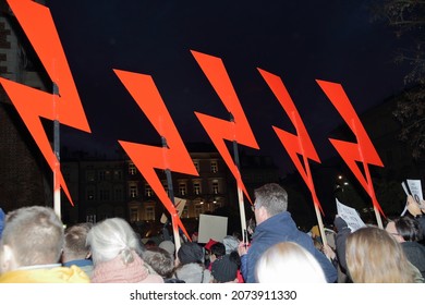 Krakow, Poland - November 7 2021: Red Big Lightnings Hold By Protesters During Street Demonstration Against Strict Anti Abortion Law In Poland, Symbol Of Women Strike Movement