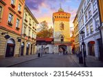 Krakow, Poland. The Saint Florian Gate (Florianska or Brama) with tower. Famous ancient landmark in krakow old town. Picturesque street morning sunrise and lamps