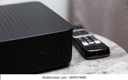 Krakow, Małopolska / Poland - September 2020: Liberty Global, UPC Set Top Box, Black Media Box And A Remote Control Laying Beside It. TV, Polish Media Provider Home Equipment, Cable Television Access