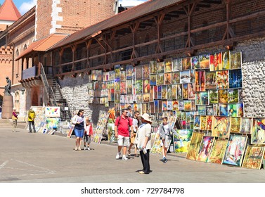 Krakow , Republic Of Poland- July 3, 2017: Trade In Painting Near The Fortress Wall Near St. Florian's Gate.