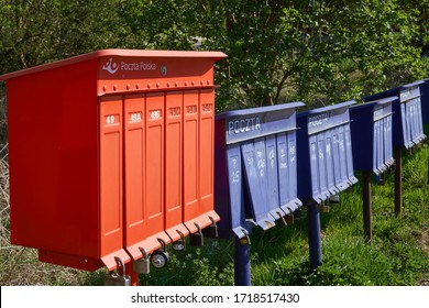 Krakow/Poland - 27 April 2020: Bright Outdoor Cluster Mail Boxes With Individual Slots In Rural Poland. The Text In Polish On The Mailbox Translates To: 'The Post Office Of Poland'                    