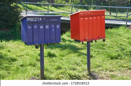 Krakow/Poland - 27 April 2020: Bright Outdoor Cluster Mail Boxes With Individual Slots In Rural Poland. The Text In Polish On The Mailbox Translates To: 'The Post Office Of Poland'                    