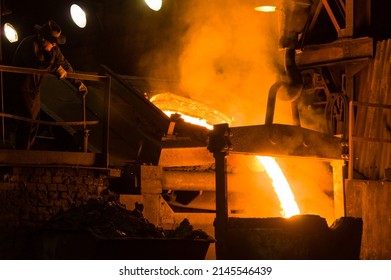 KRALUV DVUR, CZECH REPUBLIC — July 2, 2015: Metallurgist pouring hot molten metal out of furnace - Shutterstock ID 2145546439