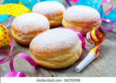 Krapfen or donuts with jam and icing sugar. Colorful carnival or birthday background