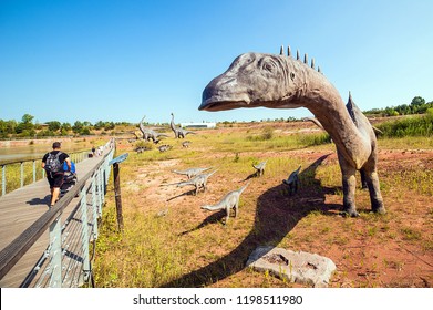 KRASIEJOW, POLAND - 21 August 2018 JuraPark - Theme Park In Poland Devoted To Dinosaurs. Visitors Passing By