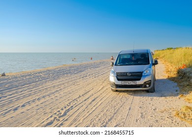 Krasnodar Region. Russia. June 11, 2022. Minivan Opel Combo Life On The Sandy Beach Of The Sea Of Azov On A Sunny Summer Day. The Concept Of Traveling To The Sea By Car.