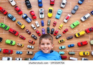 Krasnodar, Russia, 22 October 2020: The Boy Pretends To Be A Superhero By Showing His Suit Under His Shirt. Childhood, Joy, Children's Games. Boy With His Toy Car Collection