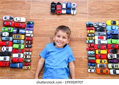 Krasnodar, Russia, 22 October 2020: The Boy Pretends To Be A Superhero By Showing His Suit Under His Shirt. Childhood, Joy, Children's Games. Boy With His Toy Car Collection