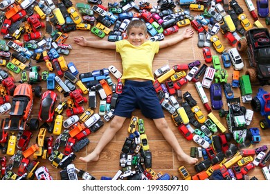 Krasnodar, Russia, 22 October 2020: The Boy Pretends To Be A Superhero By Showing His Suit Under His Shirt. Childhood, Joy, Children's Games. Boy With His Toy Car Collection