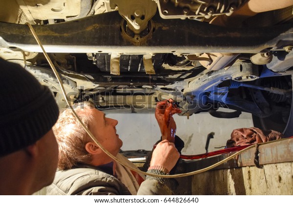 Krasnodar,\
Russia - April 22, 2017: Oil change in the automatic box of the car\
Volkswagen Tuareg. Car maintenance\
station.