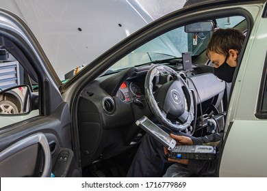 Krasnodar, Russia - April 28, 2020: Renault Auto Show In Adygea. Locksmith Works In Protective Mask. Maintenance Car Renault Duster. Quarantine. Coronavirus (Covid-19). Pandemic.