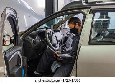 Krasnodar, Russia - April 28, 2020: Renault Auto Show In Adygea. Locksmith Works In Protective Mask. Maintenance Car Renault Duster. Quarantine. Coronavirus (Covid-19). Pandemic.