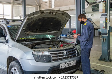 Krasnodar, Russia - April 28, 2020: Renault Auto Show In Adygea. Locksmith Works In Protective Mask. Maintenance Car Renault Duster. Quarantine. Coronavirus (Covid-19). Pandemic.