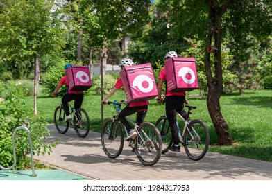 Krasnodar, Russia - June 1 2021: Citycsape In Summer Day. Food Delivery Service Providers At Work. Stay Home And Keep Life Concept. Coronavirus Pandemic. Transl. - Bringing Groceries In 15 Minutes.