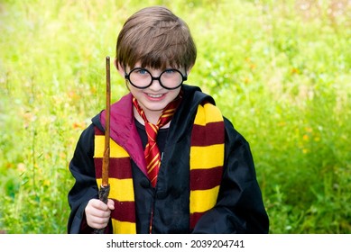 Krasnodar, Russia, October 31, 2020 Happy  Boy Dressed As Harry Potter. Portrait Of A Smiling Little Boy Dressed As A Wizard With Toy Glasses And A Magic Wand