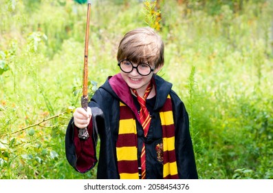 Krasnodar, Russia, October 31, 2020 Happy  Boy Dressed As Harry Potter. Portrait Of A Smiling Little Boy Dressed As A Wizard With Toy Glasses And A Magic Wand