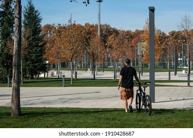 Krasnodar, Southern Federal District. Russia 08.11.2019. Man With Bicycle Walking In The Park