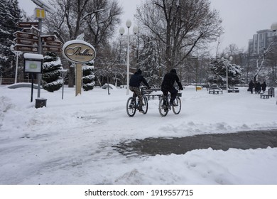 Krasnodar, Southern Federal District. Russia 15.02.2020.  A Lot Of Snow, People Ride Bicycles In The Park.