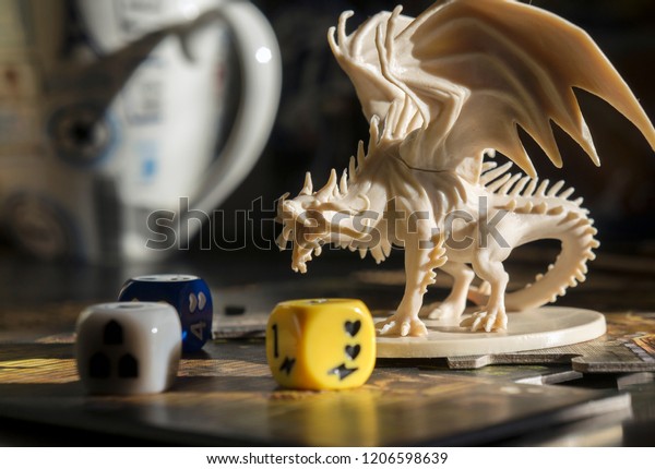 Krasnodar/Russia  – October 17, 2018: Playing Descent board game, role playing game, dungeons and dragons, dnd. Figure of dragon, dices. Board games. Blurred background.