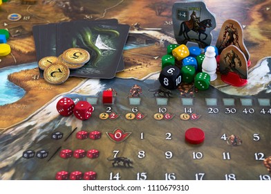Krasnodar/Russian Federation – JUNE 10, 2018: Playing Legends of Andor board game; dices, figures and tiles from the game on the map