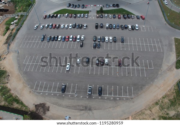 Krasnogorsk, Moscow region, Russia - 2015:\
Many parked cars in yards and streets. Empty parking lot at city\
center, aerial view. Outdoor round\
parking