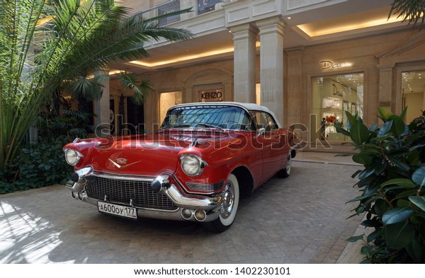 Krasnogorsk,\
Moscow region, Russia - May 17, 2019: Interior of a modern shopping\
center Vegas Crocus City. Shopping precinct or shopping mall.\
Wonderful vintage red classic\
Cadillac.