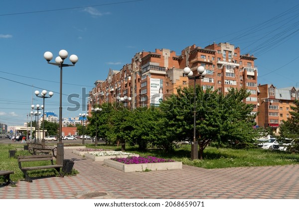 Krasnoyarsk, Krasnoyarsk\
Region, RF - July 16, 2021: The square named after the polar pilot\
Vasily Molokov against the background of a residential building on\
a sunny summer\
day.
