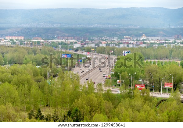 Krasnoyarsk, Krasnoyarsk Region / RF - May 14,\
2017: Tatyshev Island, along which the October Bridge is laid\
across the Yenisei River in the city of Krasnoyarsk. Krasnoyarsk\
region. Russia.