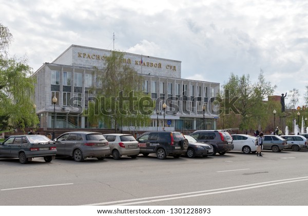 Krasnoyarsk,
Krasnoyarsk Region / RF - May 5, 2017: Cars are in the parking lot
in front of the court building (1973) of the Krasnoyarsk Territory,
on Mira Avenue on a spring cloudy
day.