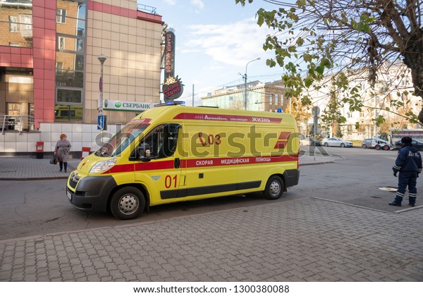 Krasnoyarsk, Krasnoyarsk Region / RF - October\
30, 2018: Yellow ambulance stands on a city street against the\
background of the Luch cinemain the\
autumn.