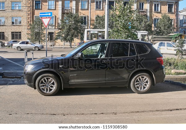  Krasnoyarsk, Russia - August 16, 2018:  BMW\
X4 xDrive28i car is parked near shop selling antiques where there\
takes place the sale. Left\
view.