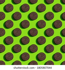 Krasnoyarsk, Russia, August 30, 2020 Oreo Cookies. Seamless Symmetrical Texture With Hard Shadows. Pattern On A Green Background.