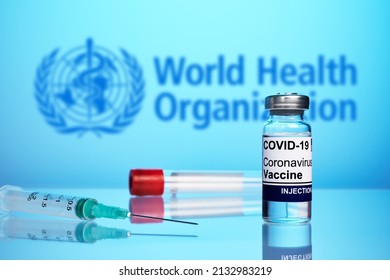 Krasnoyarsk, Russia - February 04, 2022: WHO Approved Coronavirus Vaccine And Syringe - Photo On A Blue Gradient Background. Antivirus Vaccine Against Covid Flu Infection. World Health Organization.