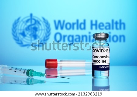 Krasnoyarsk, Russia - February 04, 2022: WHO approved coronavirus vaccine and syringe - photo on a blue gradient background. Antivirus vaccine against covid flu infection. World Health Organization. Stock photo © 