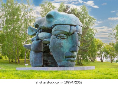 Krasnoyarsk, Russia - June 17, 2021: sculpture Transformation by the Buryat sculptor Dashi Namdakov against birch trees in summer sunny day
