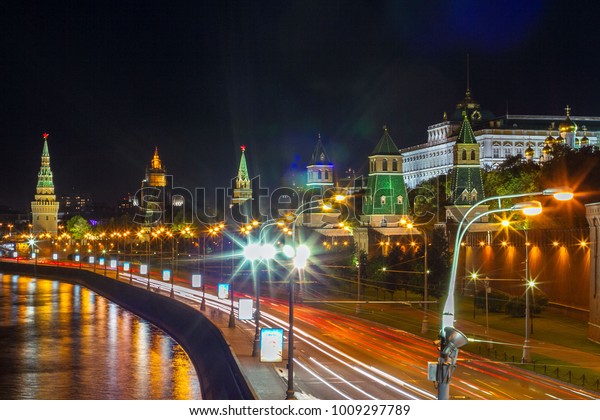 The Kremlin\
with cars rushing by in the\
night