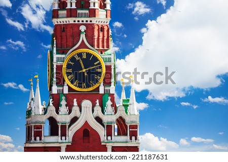Kremlin Spasskaya tower clock over sky with clouds