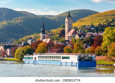 Krems cityscape and cruise boat on Danube river in autumn, Wachau valley, Austria