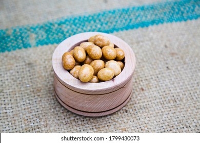 Kri Kri Peanuts In Small Wood Bowl & Texture Textile Slate Surface