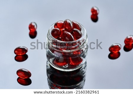 Krill oil pills or globules in a glass jar. - ealthy nutritional supplement rich in omega-3 fatty acids